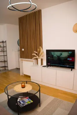 a living room with a tv and a coffee table at Apartment Infinity in Kruševac