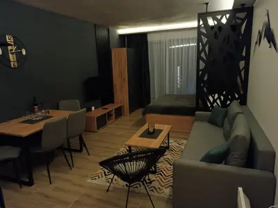 a living room with a couch and a table at XL apartments, Residence Hill, Kopaonik in Kopaonik