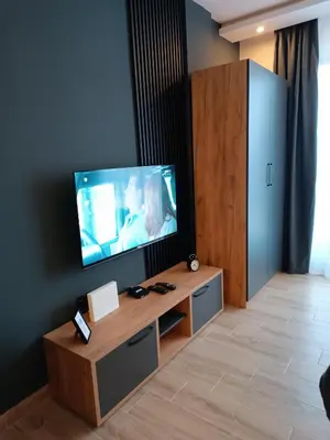 a living room with a flat screen tv on the wall at XL apartments, Residence Hill, Kopaonik in Kopaonik