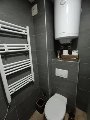 a bathroom with a white toilet and a sink at XL apartments, Residence Hill, Kopaonik in Kopaonik