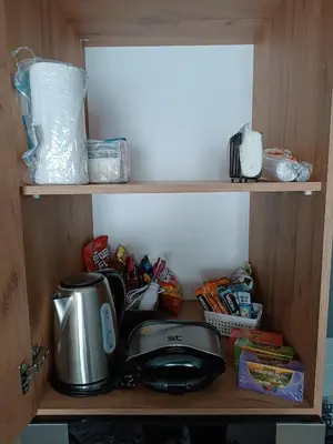 a cupboard with a toaster and a tea kettle and food at XL apartments, Residence Hill, Kopaonik in Kopaonik