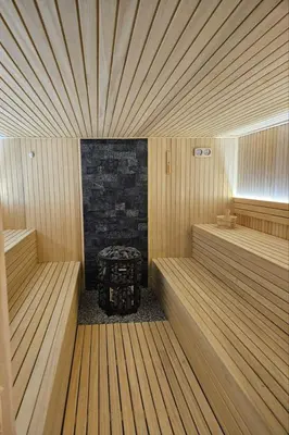 a sauna with a fireplace and a table in it at XL apartments, Residence Hill, Kopaonik in Kopaonik