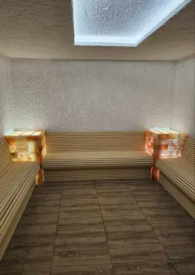 a bench in a room with two wooden benches at XL apartments, Residence Hill, Kopaonik in Kopaonik