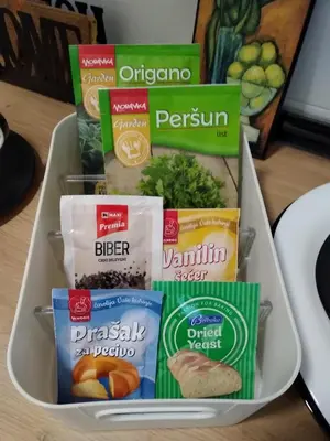a container filled with different food items on a table at OLI apartman in Niš