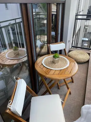 a balcony with two tables and chairs on a balcony at N Apartment in Vrnjačka Banja
