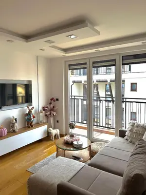 a living room with a couch and some windows at N Apartment in Vrnjačka Banja