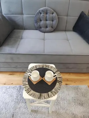 a coffee table in a living room with a couch at GALEB in Vrnjačka Banja
