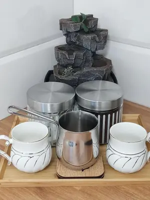 a wooden tray with dishes and a pot on it at GALEB in Vrnjačka Banja