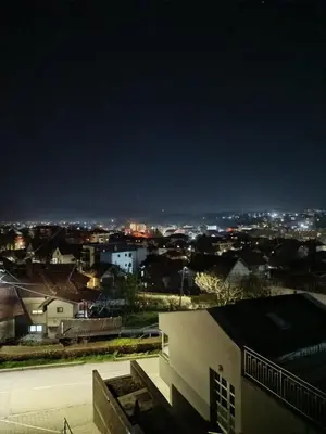 a view of a city at night at Apartman Gold in Vrnjačka Banja