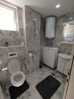 a bathroom with a toilet and a sink at Apartman Gold in Vrnjačka Banja