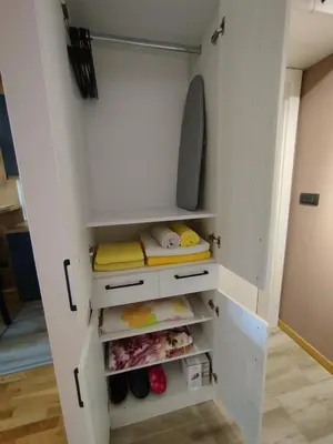 a walk in closet with white cabinets at Apartman Gold in Vrnjačka Banja
