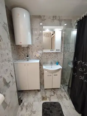 a bathroom with a sink and a shower at Apartman Gold in Vrnjačka Banja