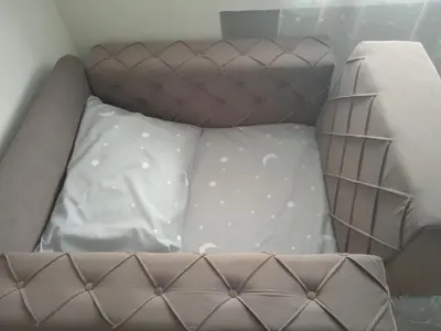 a brown bed with white sheets and pillows at MAL Apartman in Soko Banja