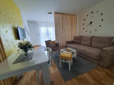 a living room with a couch and a table at Apartman IRIS in Vrnjačka Banja