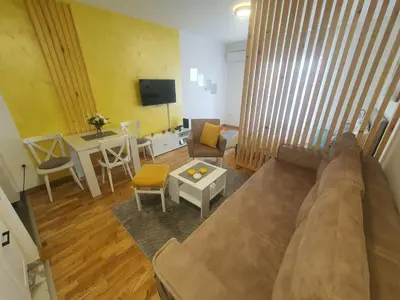 a living room with a couch and a table at Apartman IRIS in Vrnjačka Banja