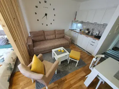 a small living room with a couch and a table at Apartman IRIS in Vrnjačka Banja
