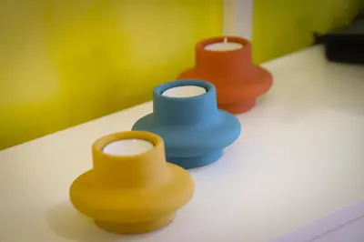 three different colored vases sitting on a table at Apartman IRIS in Vrnjačka Banja