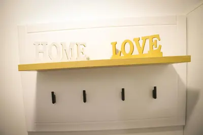 a shelf with the words home and love on it at Apartman IRIS in Vrnjačka Banja