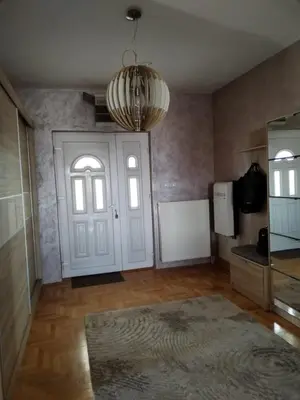 a room with a white door and a refrigerator at TEA APARTMAN in Niš