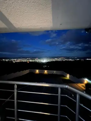 a view of a city at night from a balcony at TEA APARTMAN in Niš