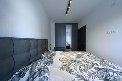 a bedroom with a large bed with a blanket at Anja Sousza Apartment in Kopaonik