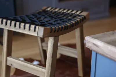 a stool with a black cushion on top of it at Anja Sousza Apartment in Kopaonik