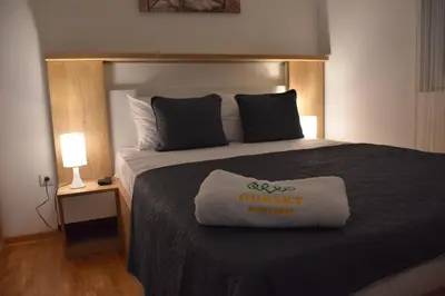 a hotel room with a bed with a odyssey sign on it at Apartman Gorsky in Vrnjačka Banja