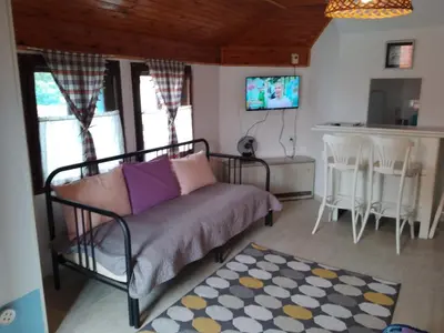 a living room with a couch and a kitchen at Garičkina kuća 2 in Pirot