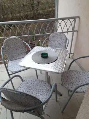 a table with a hat sitting on top of it at B&P apartman Vrnjačka Banja in Vrnjačka Banja
