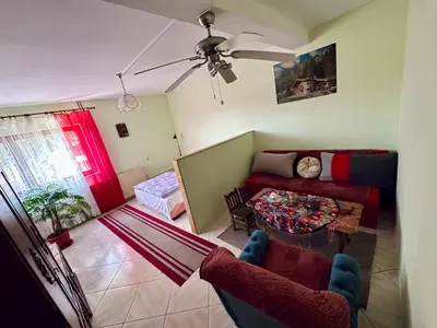 a living room with a couch and a table at Seosko turističko domaćinstvo DUNJA in Osnić
