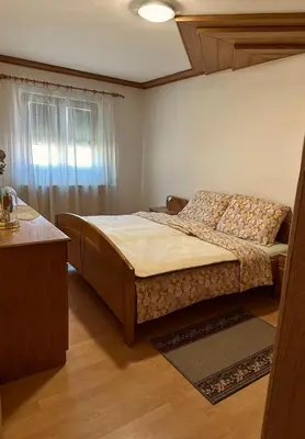 a small bedroom with a bed and a window at Seosko turističko domaćinstvo DUNJA in Osnić