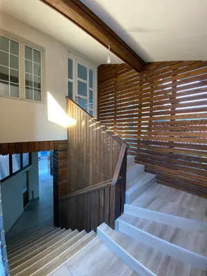 a staircase in a house with a wooden wall at Apartments and Rooms Radivojević Niš in Niš