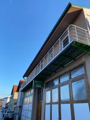 a building with a balcony on the top of it at Apartments and Rooms Radivojević Niš in Niš