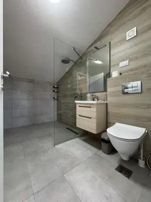 a bathroom with a toilet and a shower and a sink at Triangle Rooms in Raška