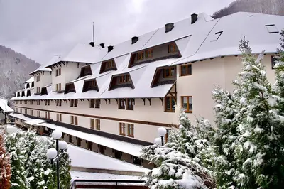 a large building with snow on the roof at Apartman Snezni Vrh - Bela Reka, Brzece in Brzeće