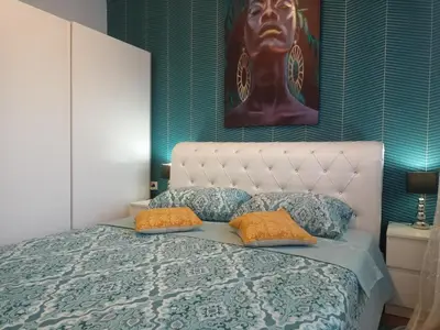 a bedroom with a bed with two pillows at OPERA LUX APARTMENTS Green Hill - Relax & Free Parking in Soko Banja