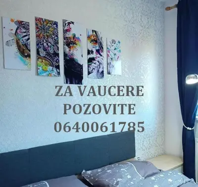 a bedroom with a za refugee sign on the wall at OPERA LUX APARTMENTS Green Hill - Relax & Free Parking in Soko Banja