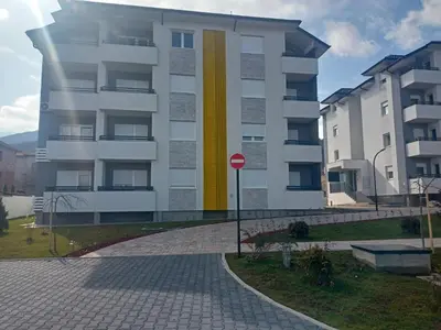 a building with a yellow stripe on the side of it at OPERA LUX APARTMENTS Green Hill - Relax & Free Parking in Soko Banja