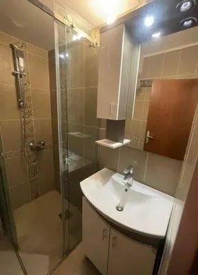 a bathroom with a sink and a shower at Bela Reka Gondola Studio in Brzeće