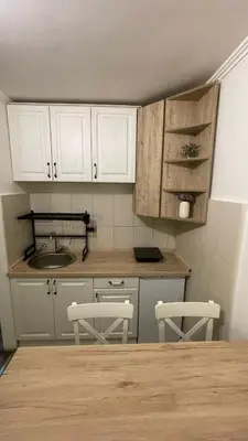 a kitchen with white cabinets and a table and chairs at Bela Reka Gondola Studio in Brzeće