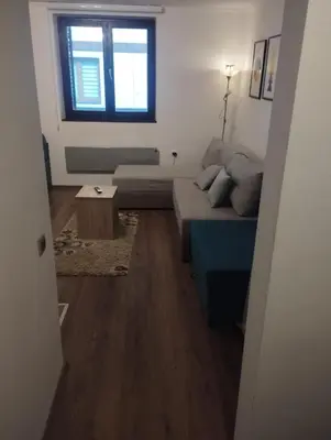 a living room with a couch and a table at Bela Reka Gondola Studio in Brzeće