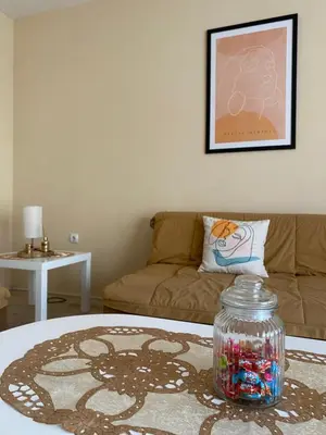 a living room with a table and a couch at Apartmani Dora Leskovac in Leskovac