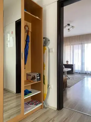 a room with a door open to a room with a refrigerator at Apartmani Dora Leskovac in Leskovac