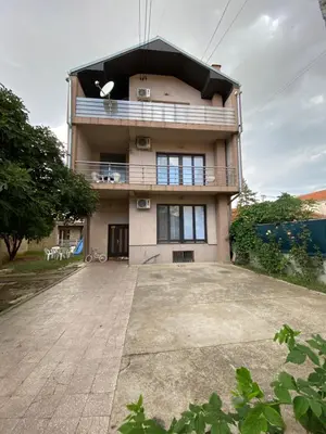 a house with a large driveway in front of it at Apartmani Dora Leskovac in Leskovac