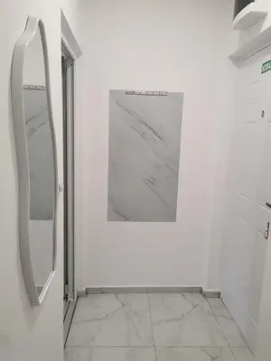 a bathroom with a mirror and a picture on the wall at Apartman Aleksandar 2 in Ribarska Banja