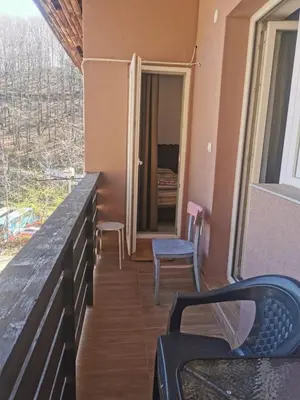 a balcony with a table and chairs and a window at Apartman Aleksandar 2 in Ribarska Banja