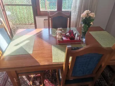 a wooden table with a vase with a teddy bear on it at Apartman Kotin in Pirot