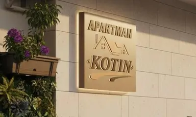 a sign on the side of a building at Apartman Kotin in Pirot