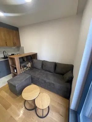 a living room with a couch and two tables at Jutarnja Zvezda Kop in Kopaonik