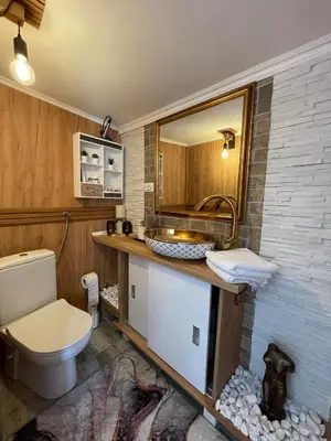 a bathroom with a toilet and a sink at Diamona Lux Spa Apartman in Niš